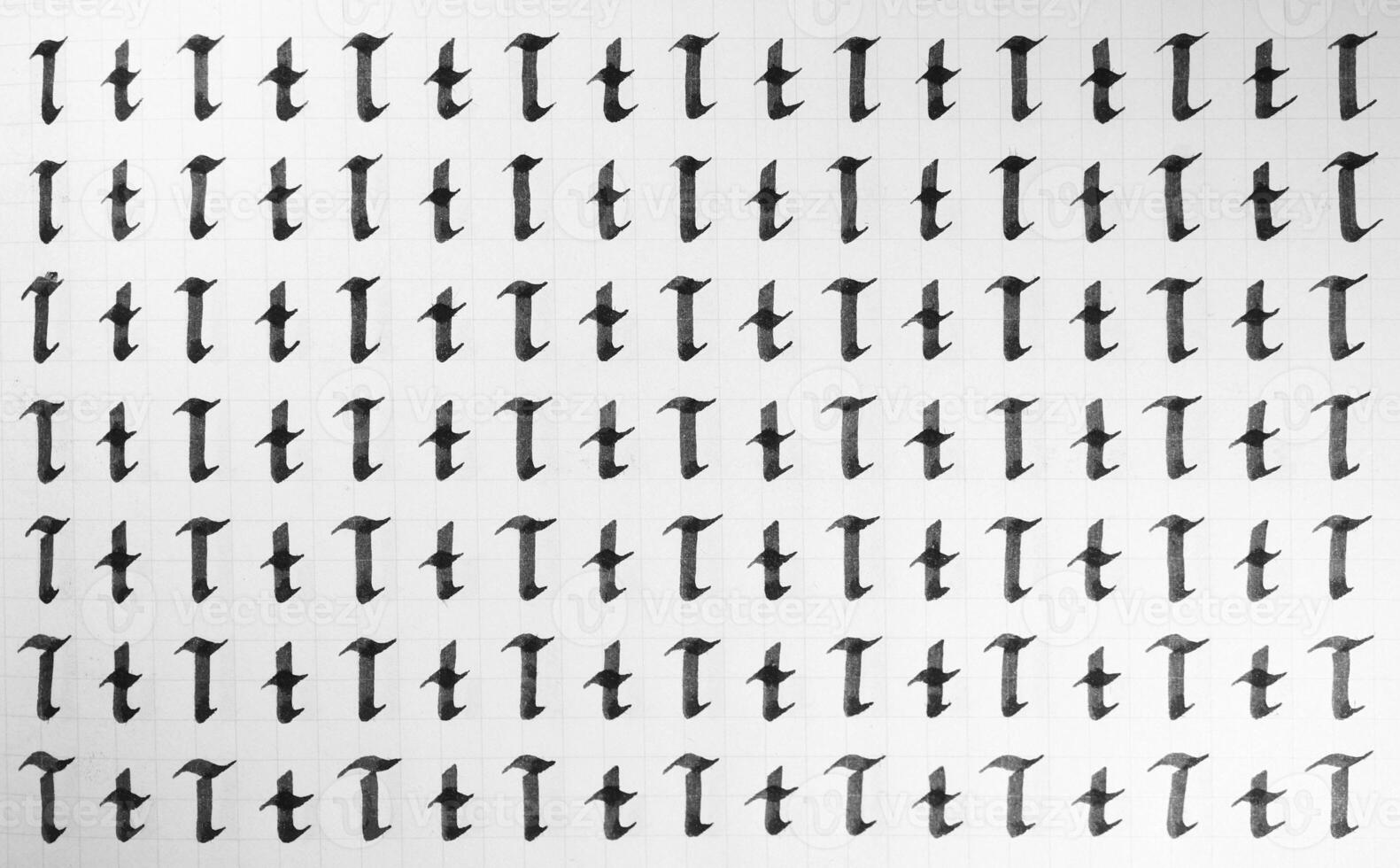 Calligraphy black and white letters T background. Lettering practice writing worksheet. Handwriting symbol filling pattern. Calligraphic letter t learning skills paper page. photo