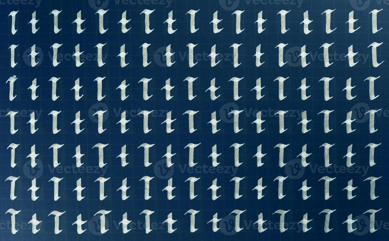 Calligraphic white on dark blue letter T learning skills paper page. Calligraphy letters t background. Lettering practice writing worksheet. Handwriting symbol filling pattern. photo