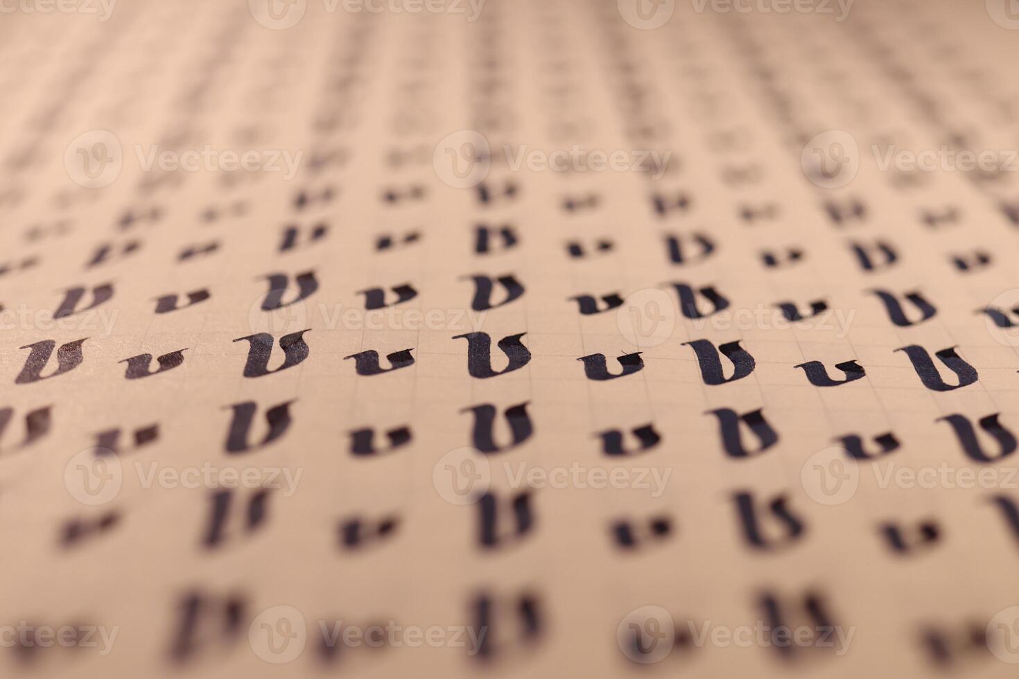 Calligraphic letter V learning skills paper page. Calligraphy letters v background. Lettering practice writing worksheet. Handwriting symbol filling pattern. photo