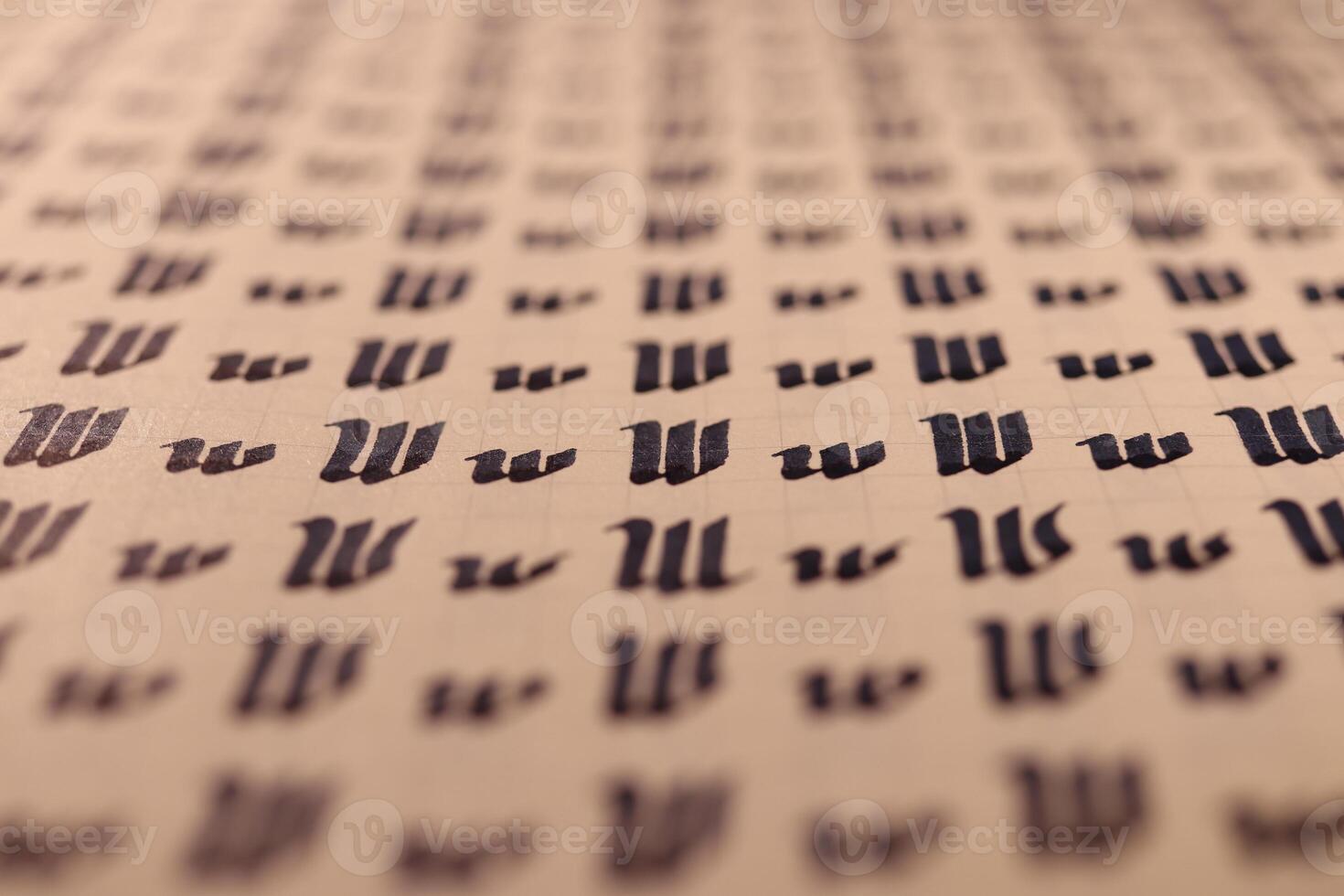 Lettering practice writing worksheet. Handwriting symbol filling pattern. Calligraphic letter W learning skills paper page. Calligraphy letters w background. photo