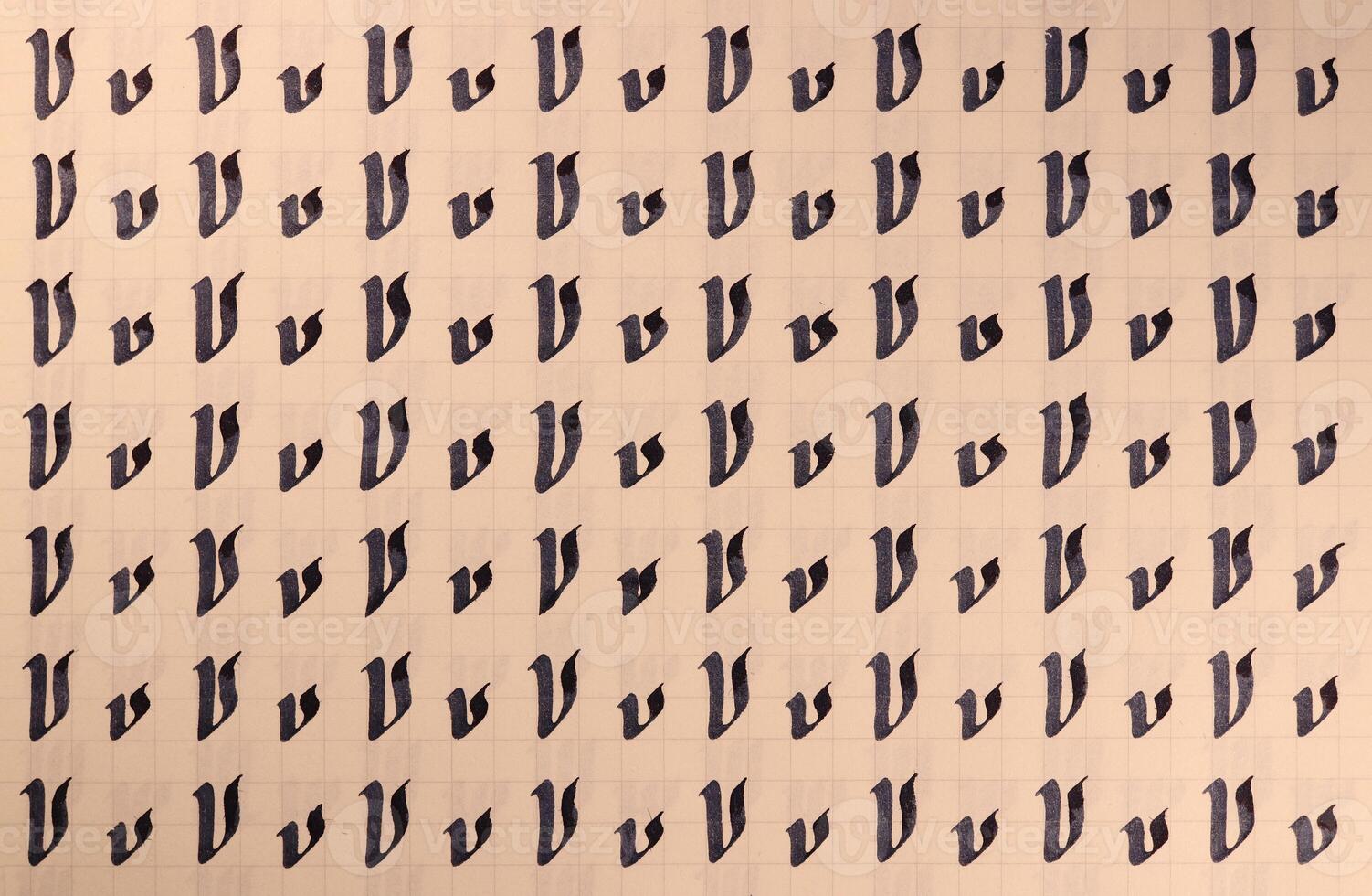 Handwriting symbol filling pattern. Calligraphic letter V learning skills paper page. Calligraphy letters v background. Lettering practice writing worksheet. photo