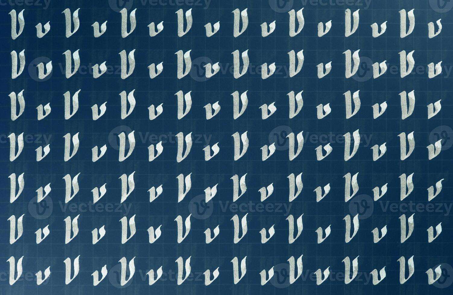 Handwriting white on dark blue symbol filling pattern. Calligraphic letter V learning skills paper page. Calligraphy letters v background. Lettering practice writing worksheet. photo
