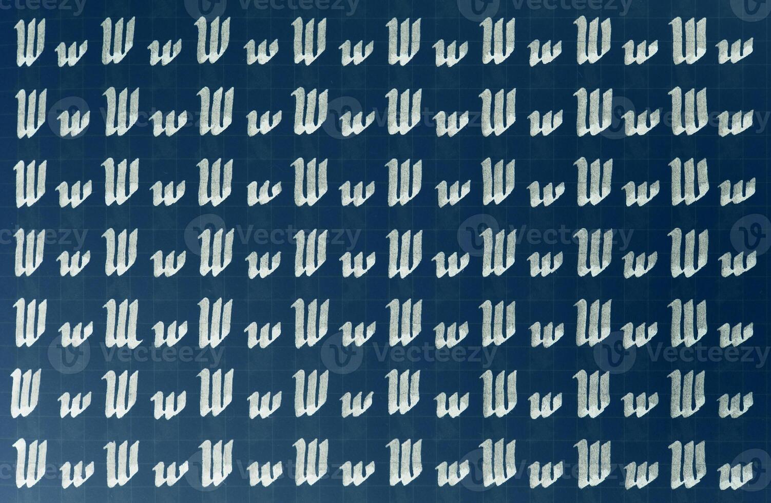 Lettering white on dark blue practice writing worksheet. Handwriting symbol filling pattern. Calligraphic letter W learning skills paper page. Calligraphy letters w background. photo