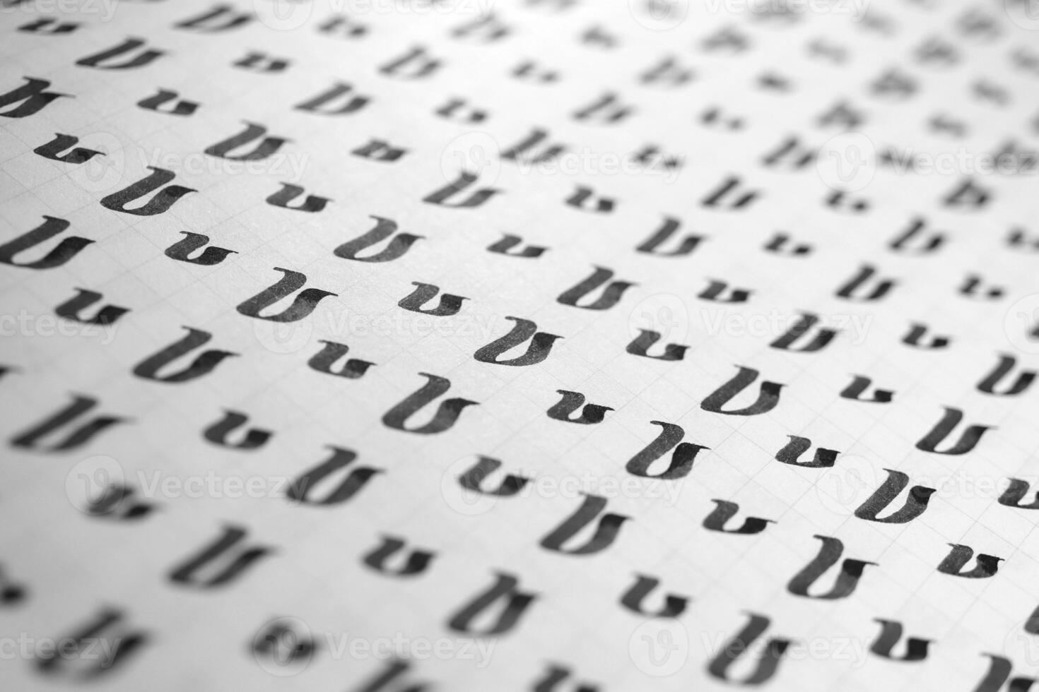 Handwriting black and white symbol filling pattern. Calligraphic letter V learning skills paper page. Calligraphy letters v background. Lettering practice writing worksheet. photo