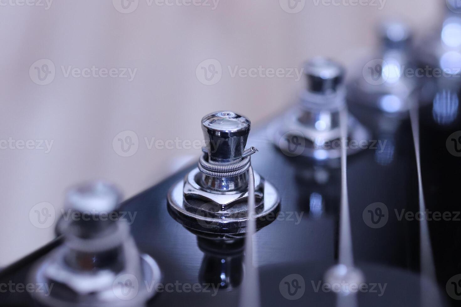 Holding string guitar tuning key. Music instruments background. Musician lifestyle instrument backdrop. photo