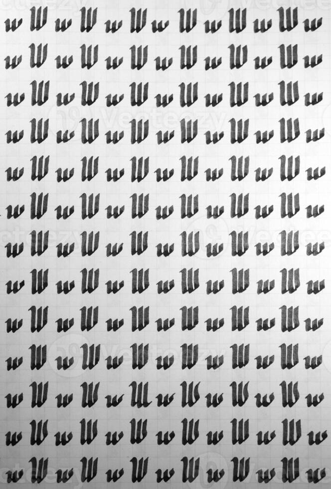 Calligraphy black and white letters W background. Lettering practice writing worksheet. Handwriting symbol filling pattern. Calligraphic letter w learning skills paper page. photo