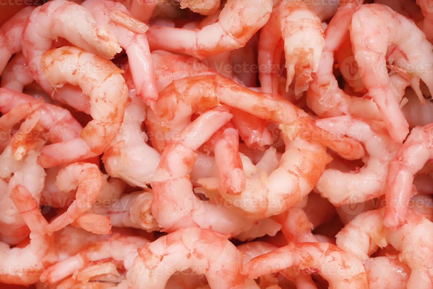 Boiled peeled shrimps meat texture. Prawns snack filling background. photo