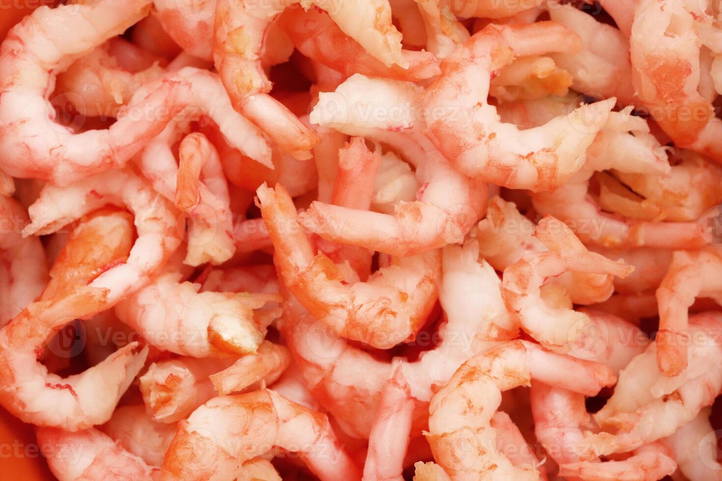 Boiled peeled shrimps meat texture. Prawns snack filling background. photo
