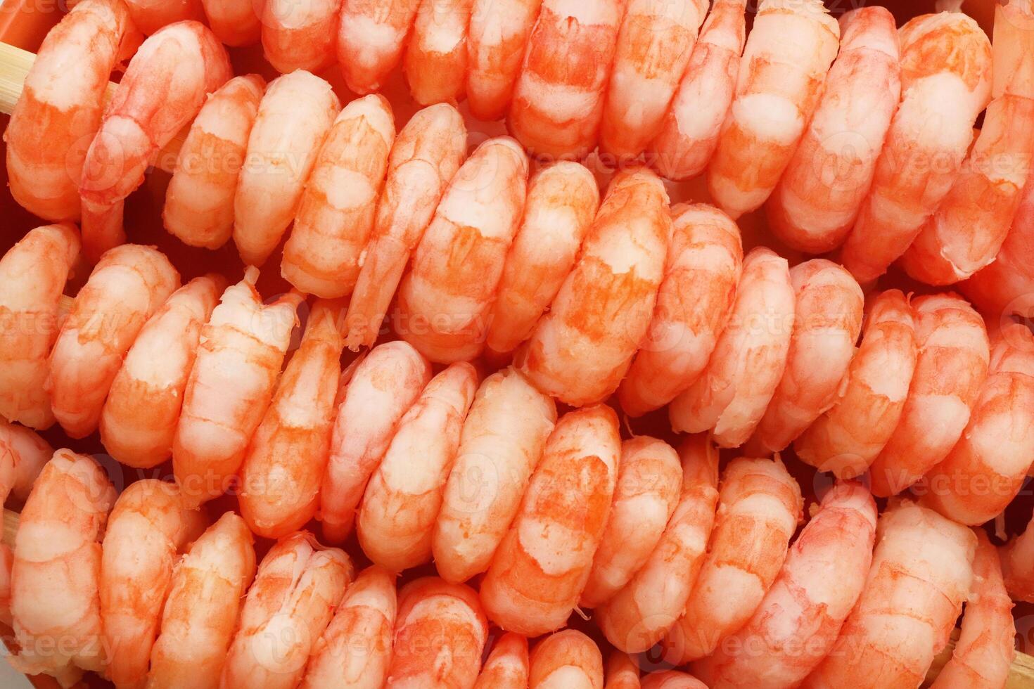 Rows of peeled boiled shrimp filling texture. Many cooked prawns background. photo