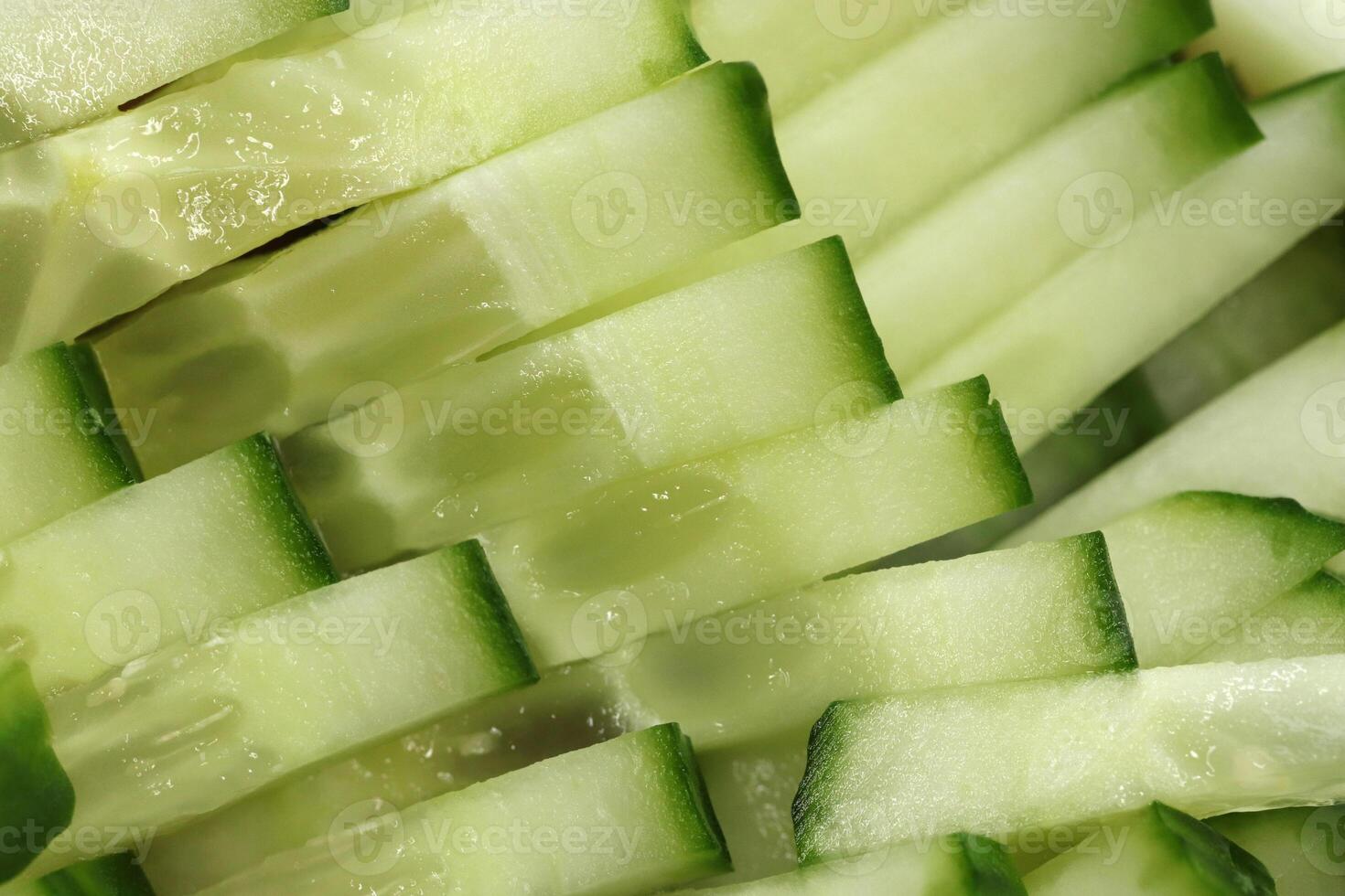 Sliced cucumber background. Diced salad ingredient texture. Fresh vitamin backdrop. photo