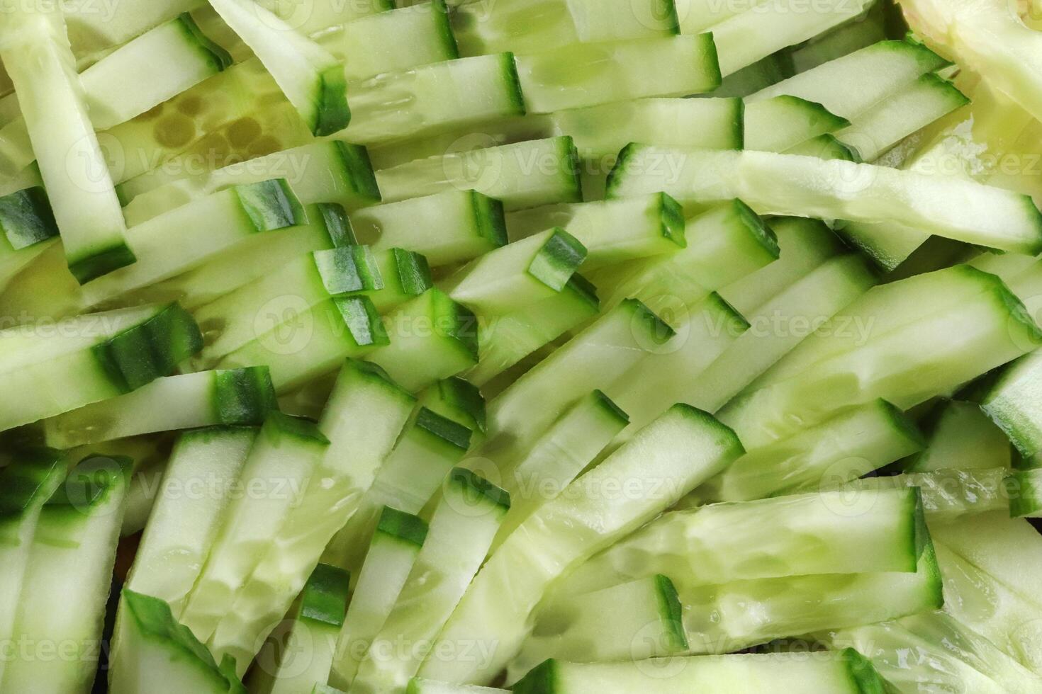 Diced salad ingredient texture. Fresh vitamin backdrop. Sliced cucumber background. photo