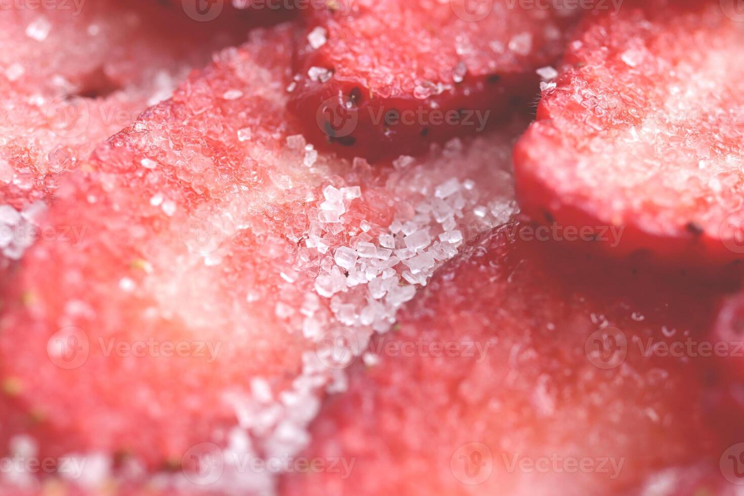 Sliced strawberry in sugar filling background. Red healthy tasty strawberry with sugar texture. Fresh vitamin berry backdrop. photo