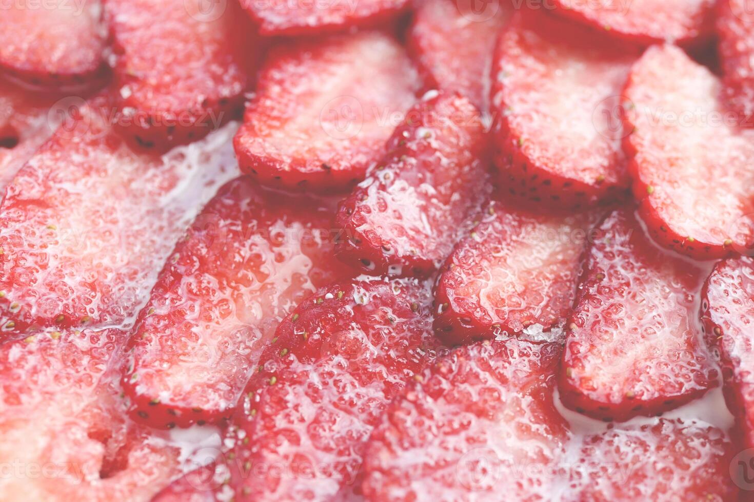 Fresh vitamin berry backdrop. Sliced strawberry in sugar cream filling background. Red healthy tasty strawberry with sugar plum texture. photo