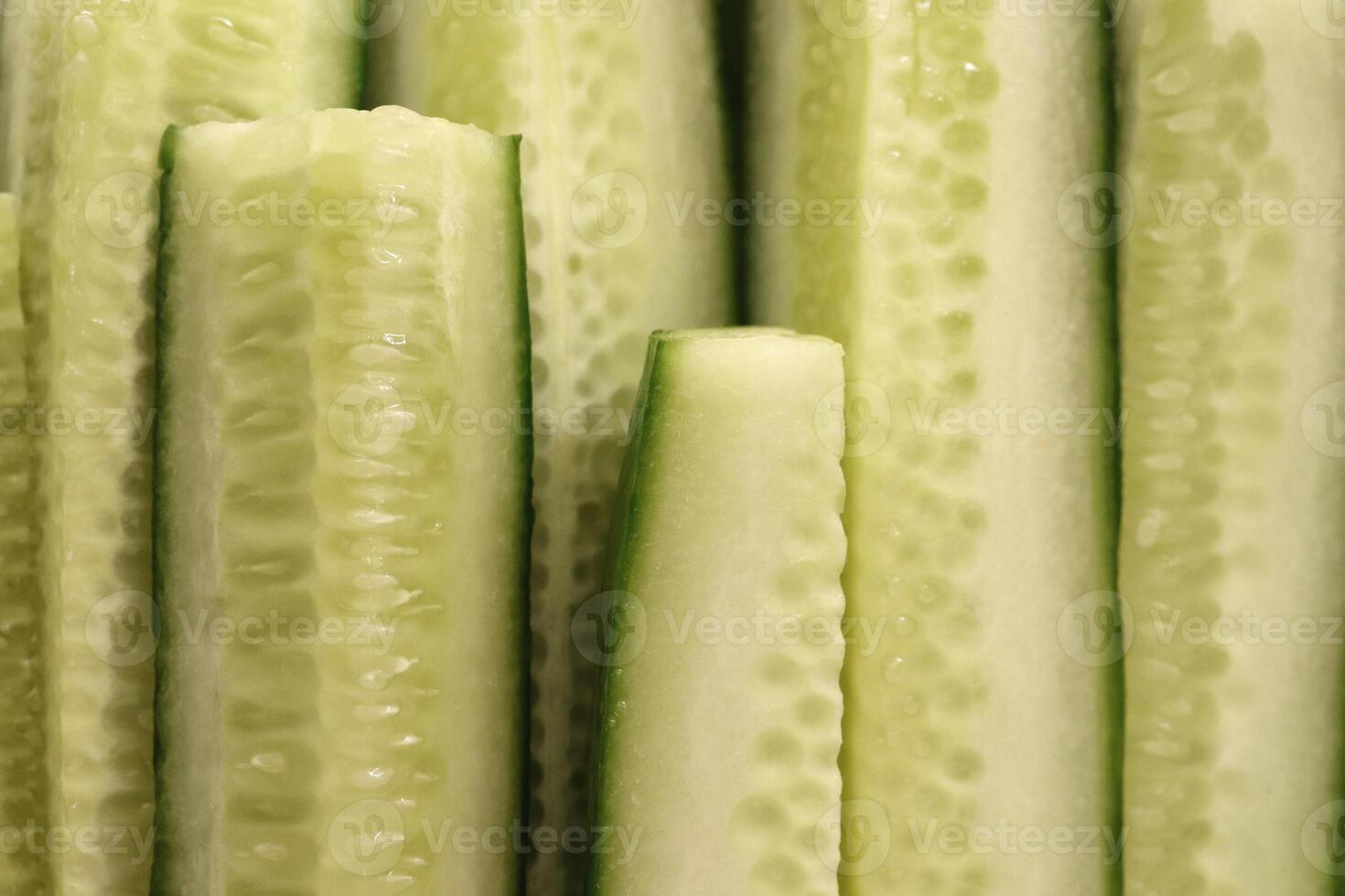Sliced cucumber pieces on a plate. Organic healthy food. Filling background.Sliced cucumber pieces. Organic healthy food slices. Filling background. photo