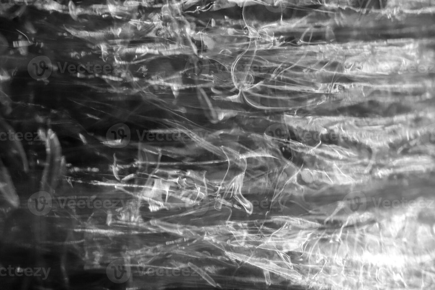 Plastic light reflection filling background. Crumpled cellophane texture. photo