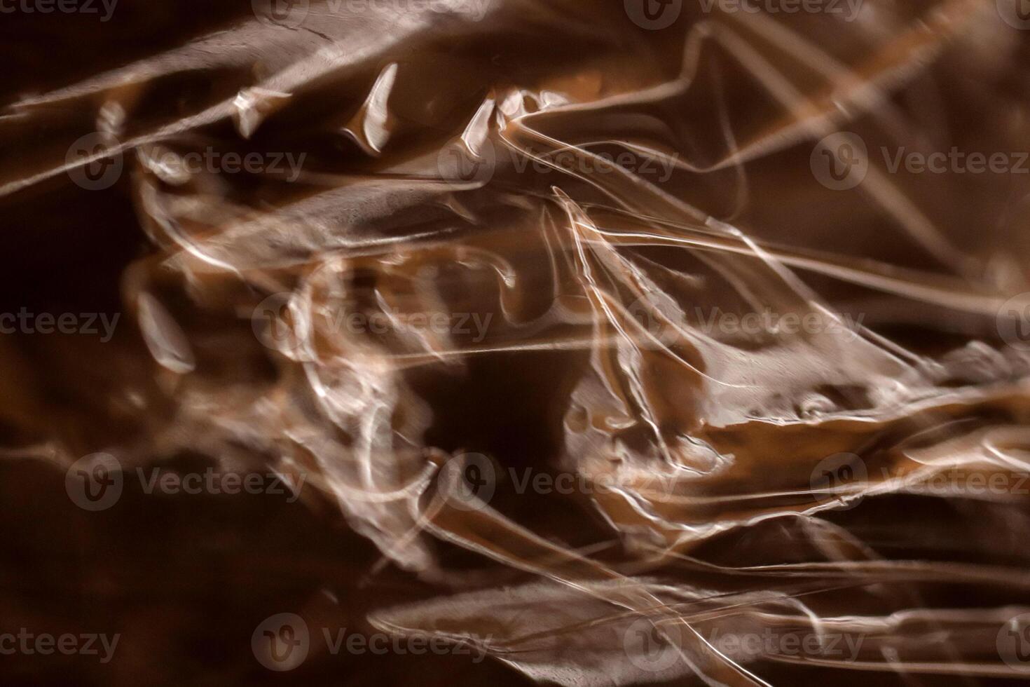 Drawing of the glowing rays of the sun on crumpled cellophane. Filling background. photo