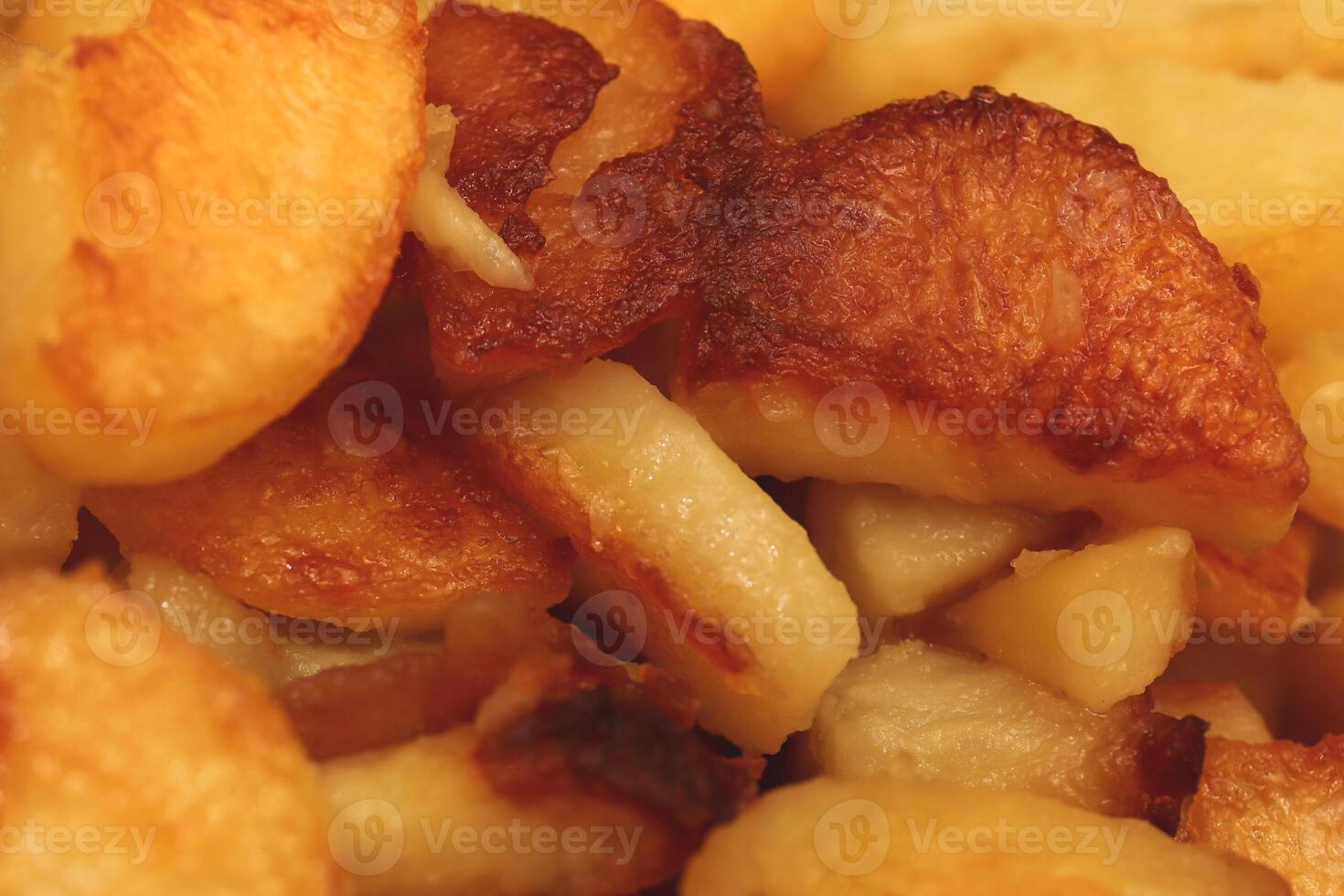 Fried potatoes slices filling background. Fry potato texture. photo