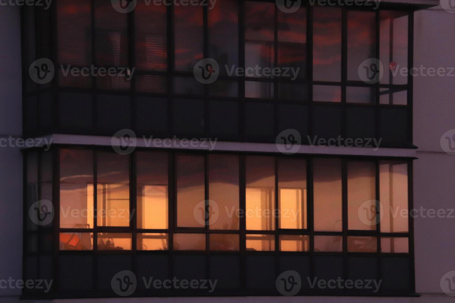 Residential building balcony with orange sky windows reflection photo
