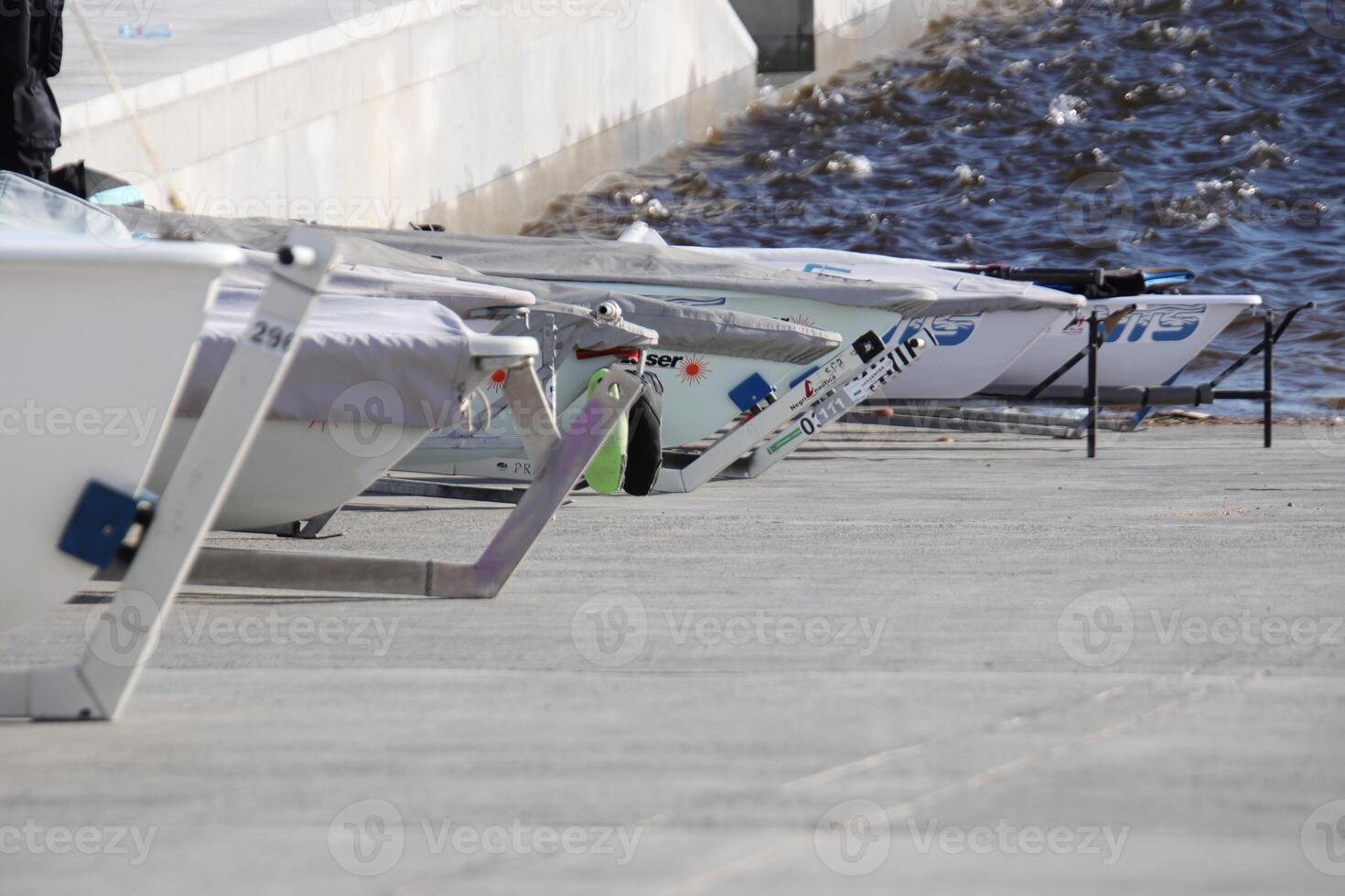 Row of prows of yachts stand on a slope ready to race photo