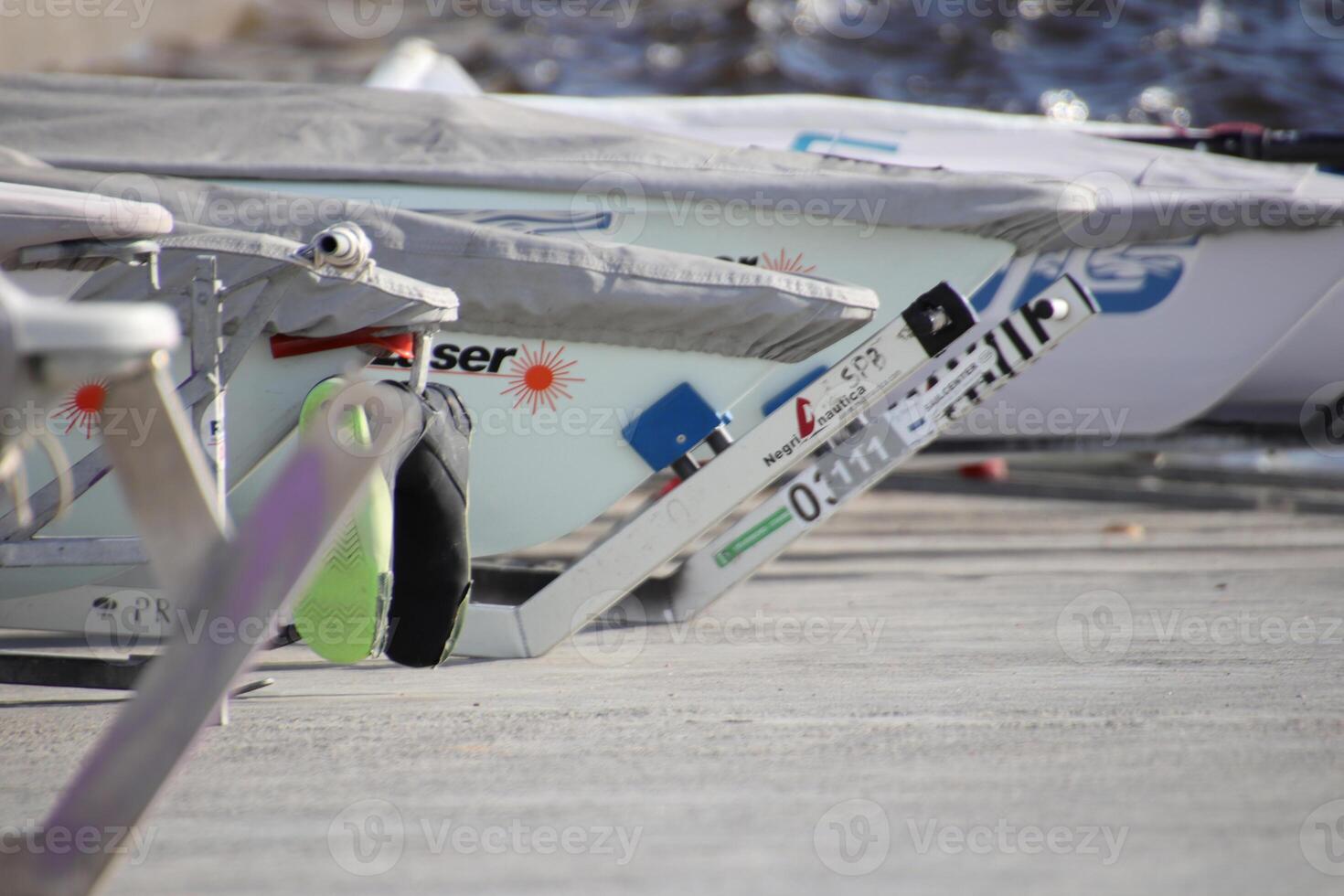 Row of prows of yachts stand on a slope ready to race photo