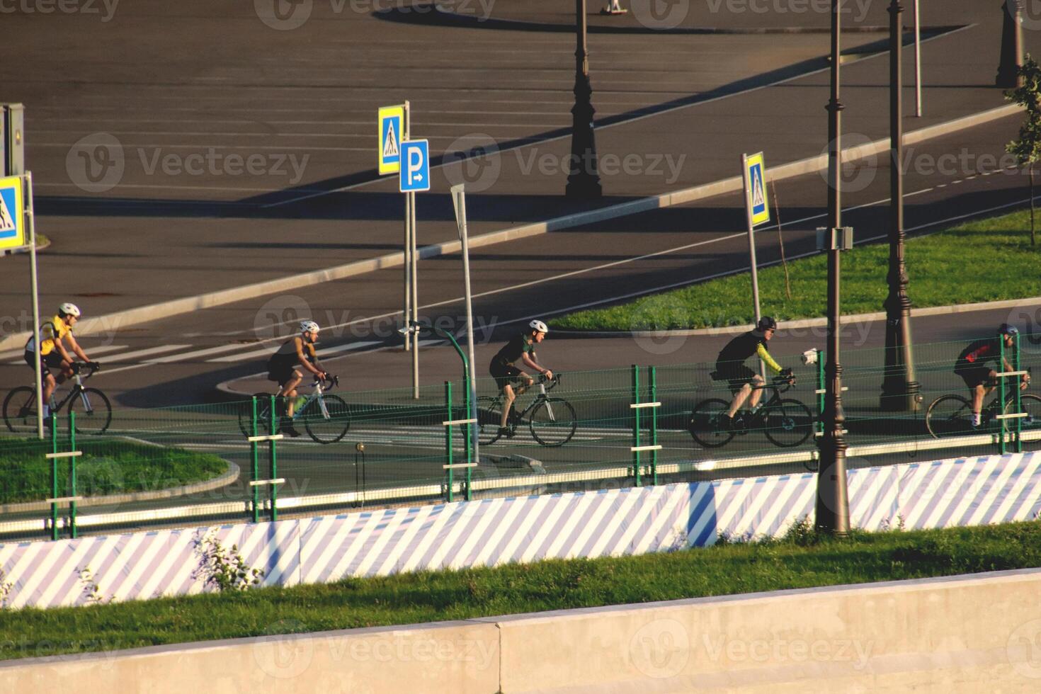 A group of cyclists crosses the construction of the city line of the Gulf of Finland photo