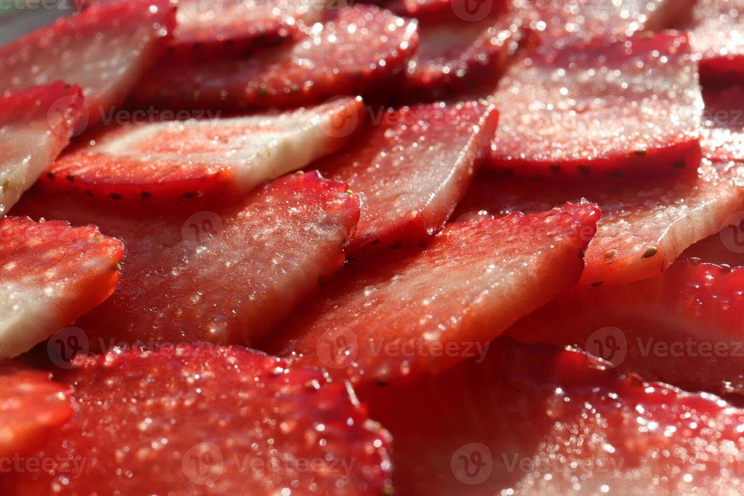 Strawberry slices with sugar. Sweet Berry background. Tasty delicious background. photo