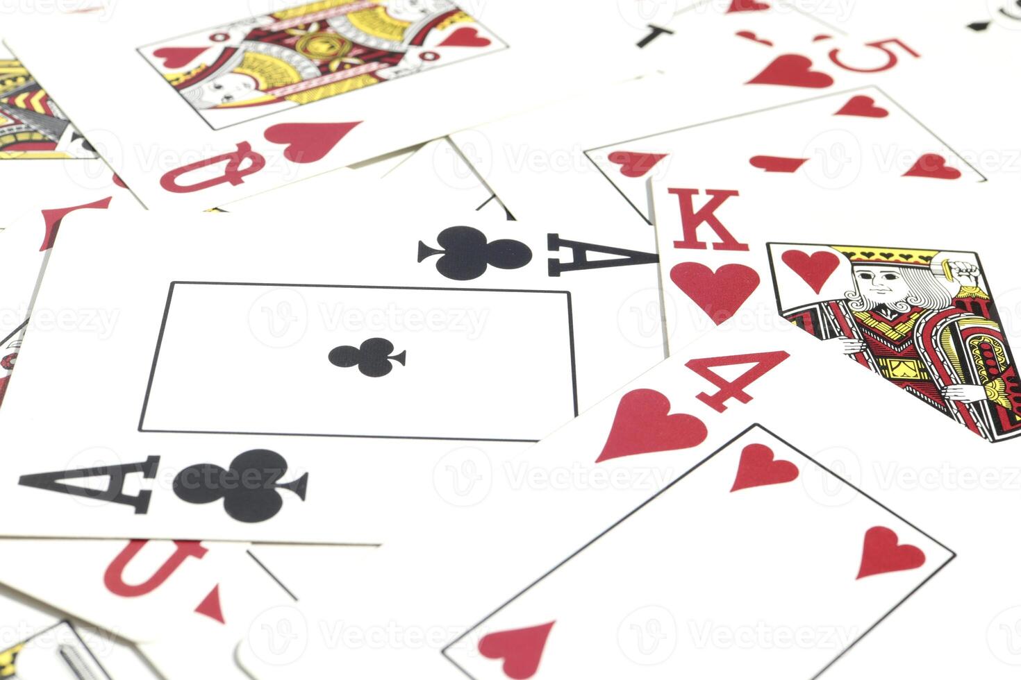 Many miscellaneous jumbled playing cards surface. Mixed playing cards background. Assorted play cards backdrop. photo
