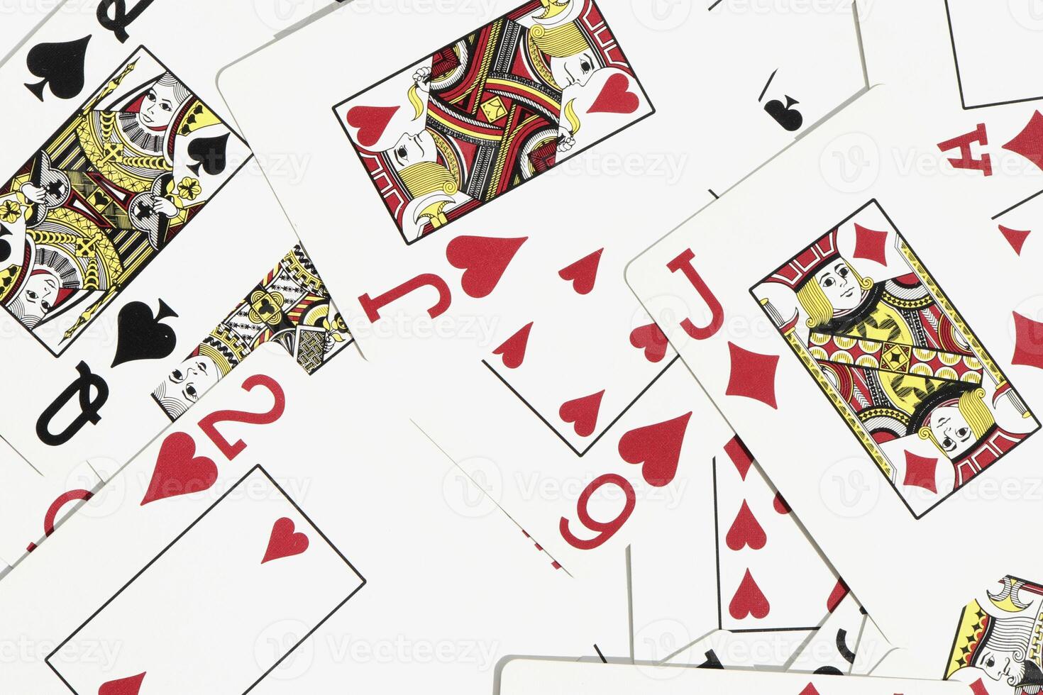 Assorted play cards backdrop. Many miscellaneous jumbled playing cards surface. Mixed playing cards background. photo