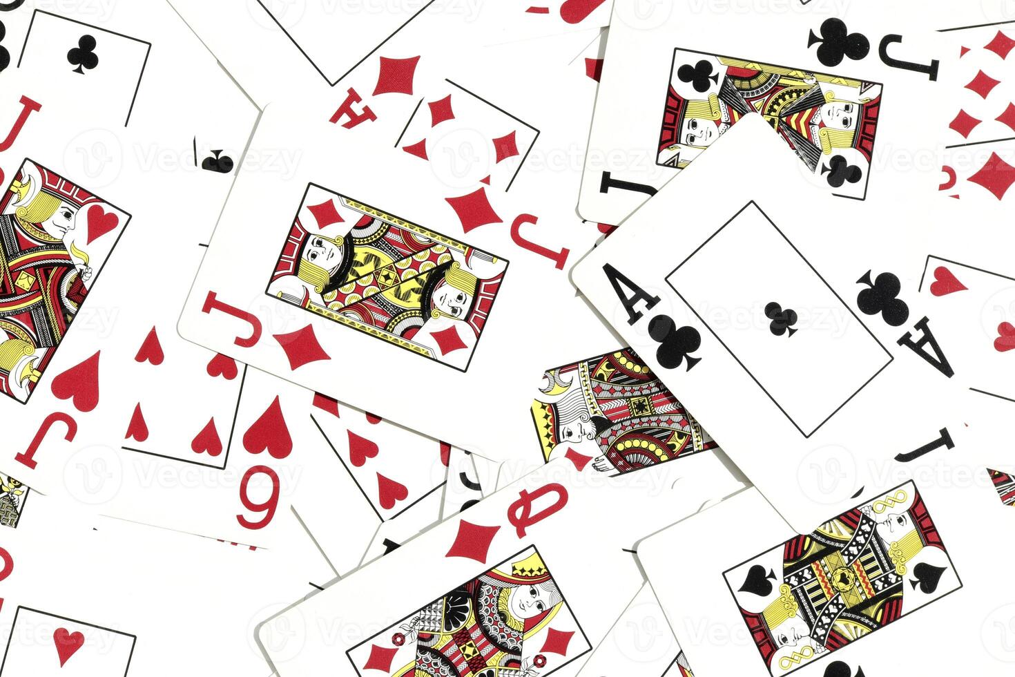 Many miscellaneous jumbled playing cards surface. Mixed playing cards background. Assorted play cards backdrop. photo
