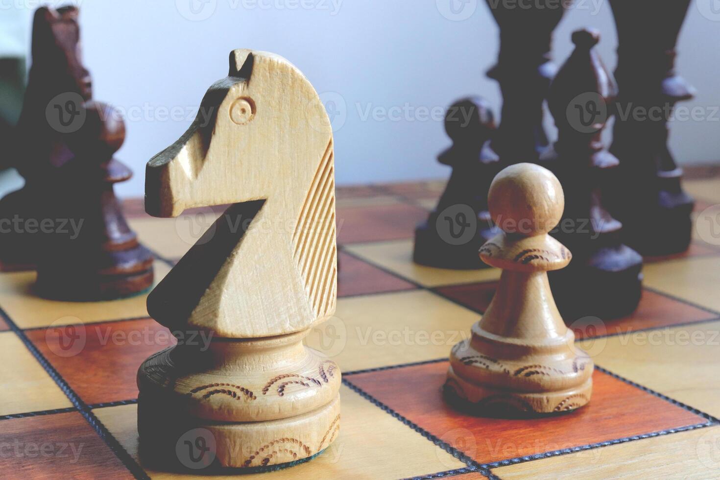 White horse and pawn chess figures background. Wood game chessboard. photo