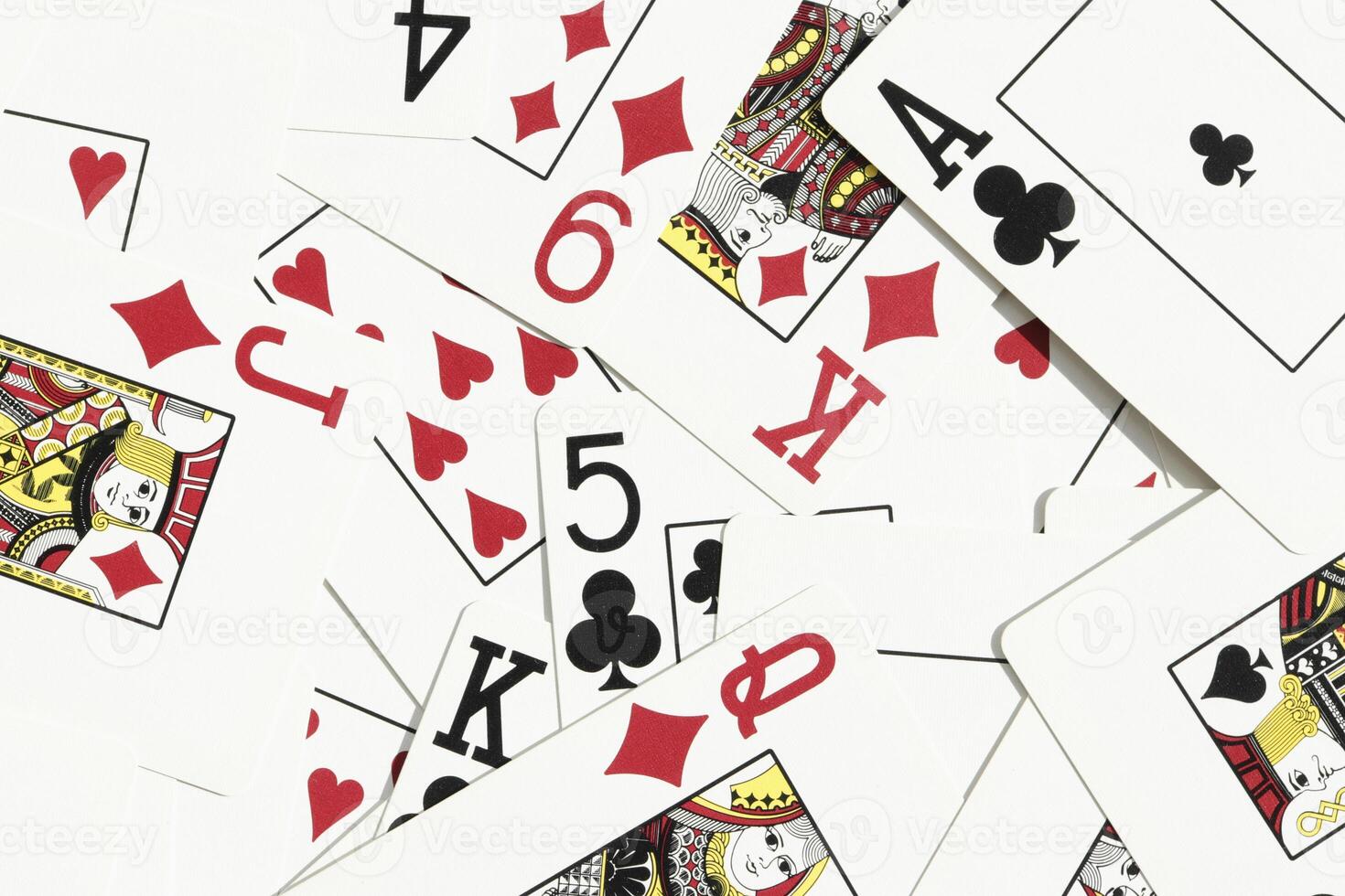 Many miscellaneous jumbled playing cards surface. Mixed playing cards background. Assorted play cards backdrop. photo