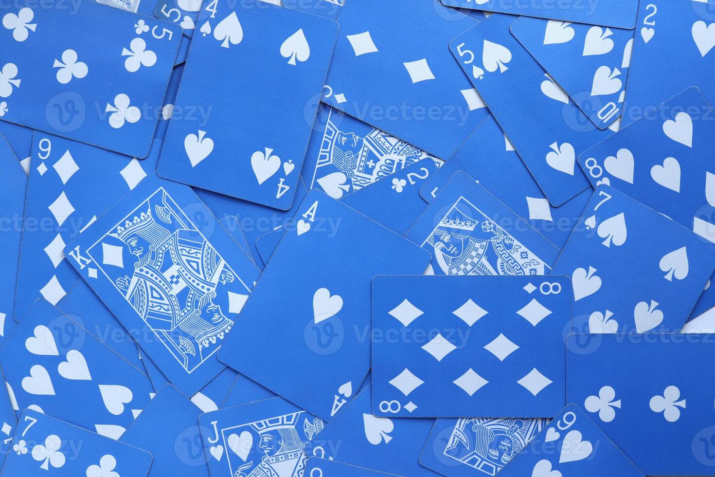 Many miscellaneous jumbled blue playing cards surface. Mixed playing cards background. Assorted play cards backdrop. photo