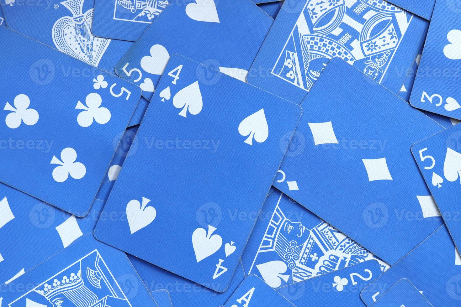 Many miscellaneous jumbled blue playing cards surface. Mixed playing cards background. Assorted play cards backdrop. photo