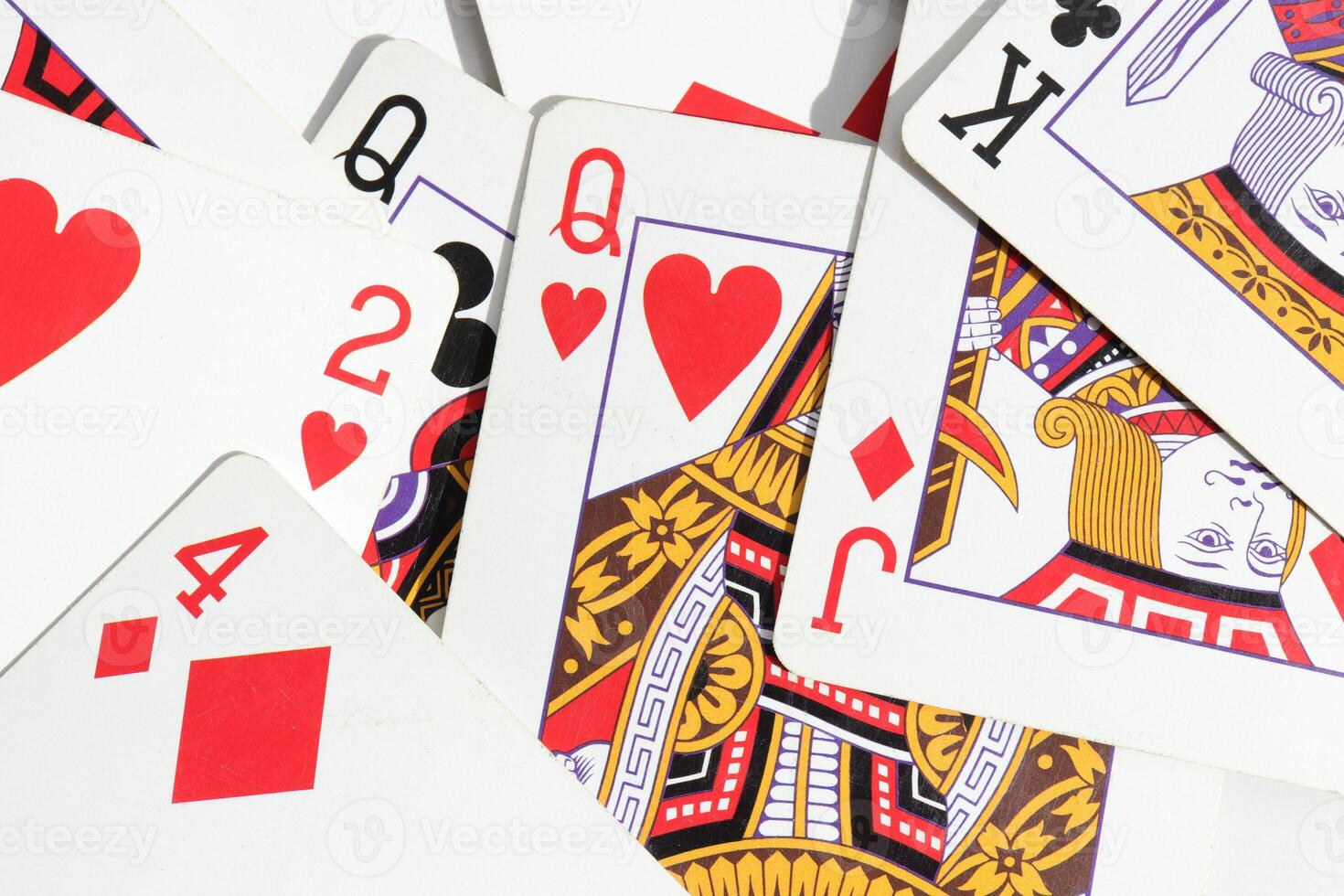 Assorted play cards backdrop. Many miscellaneous jumbled playing cards surface. Mixed playing cards background. photo
