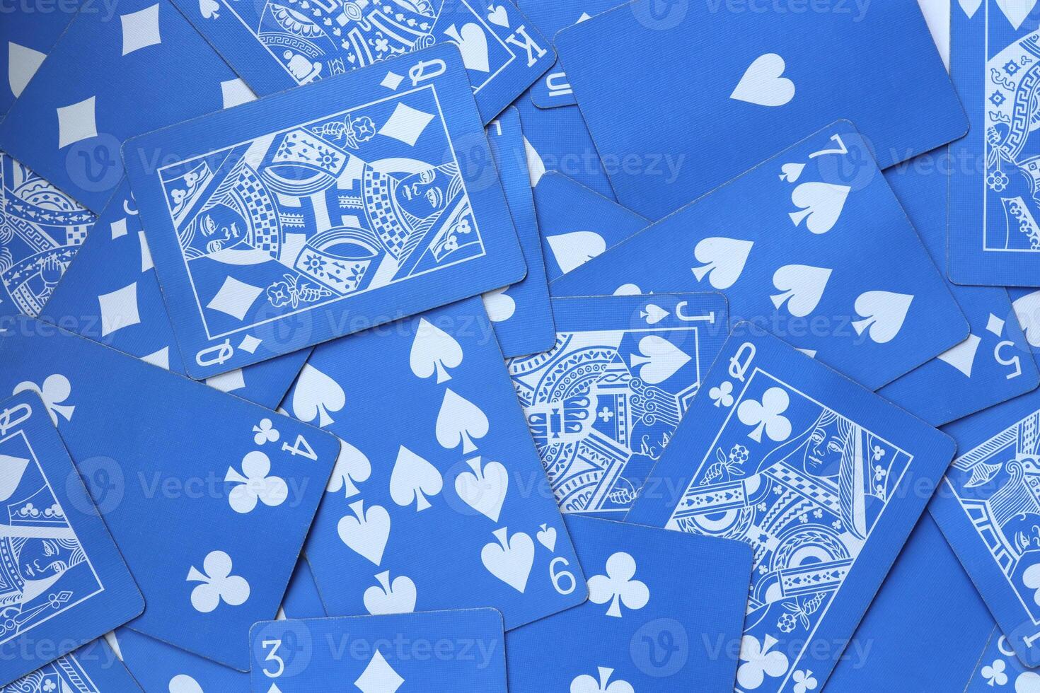 Mixed playing cards background. Assorted play cards backdrop. Many miscellaneous jumbled blue playing cards surface. photo