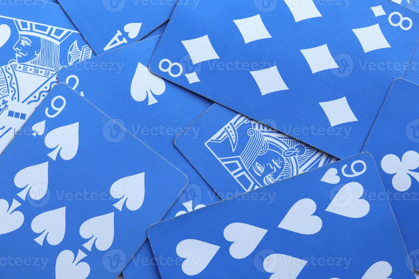 Many miscellaneous jumbled blue playing cards surface. Mixed playing cards background. Assorted play cards backdrop. photo