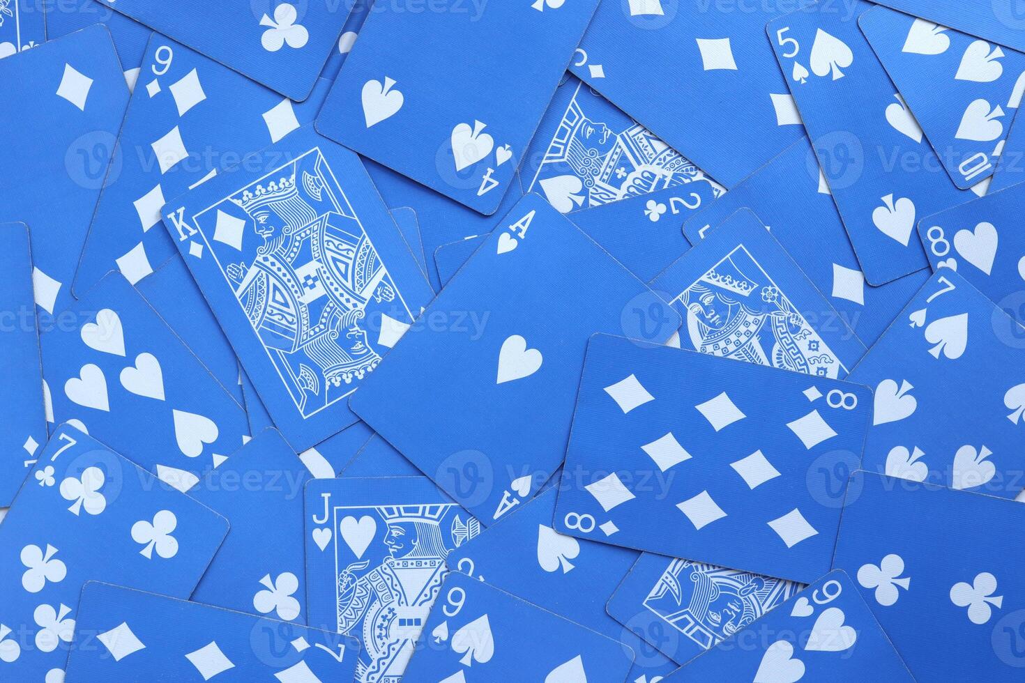 Mixed playing cards background. Assorted play cards backdrop. Many miscellaneous jumbled blue playing cards surface. photo