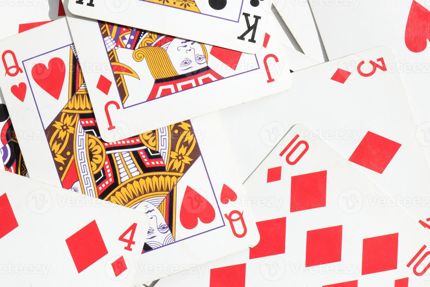 Many miscellaneous jumbled playing cards surface. Mixed playing cards background. Assorted play cards backdrop. photo