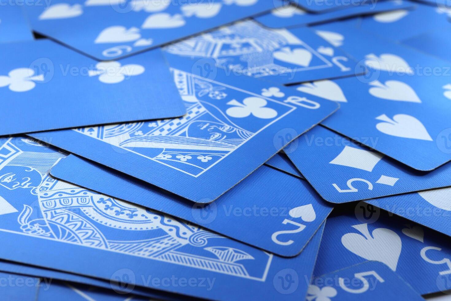 Many miscellaneous jumbled blue playing cards. Mixed playing cards background. Assorted play cards backdrop. photo