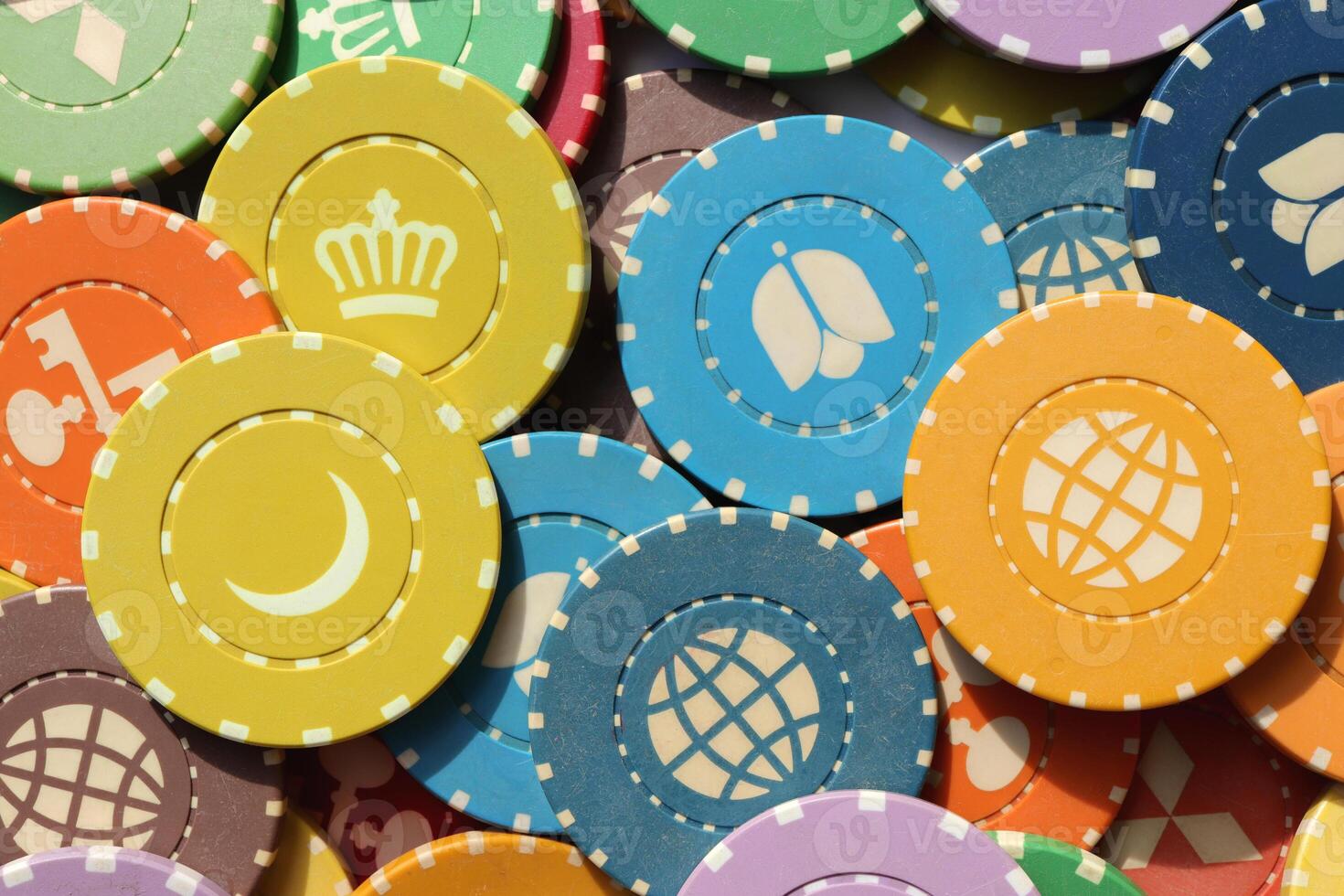 Lot multicolor assorted gambling playing chips surface. Colorful casino chips background. Many colored chips backdrop. photo
