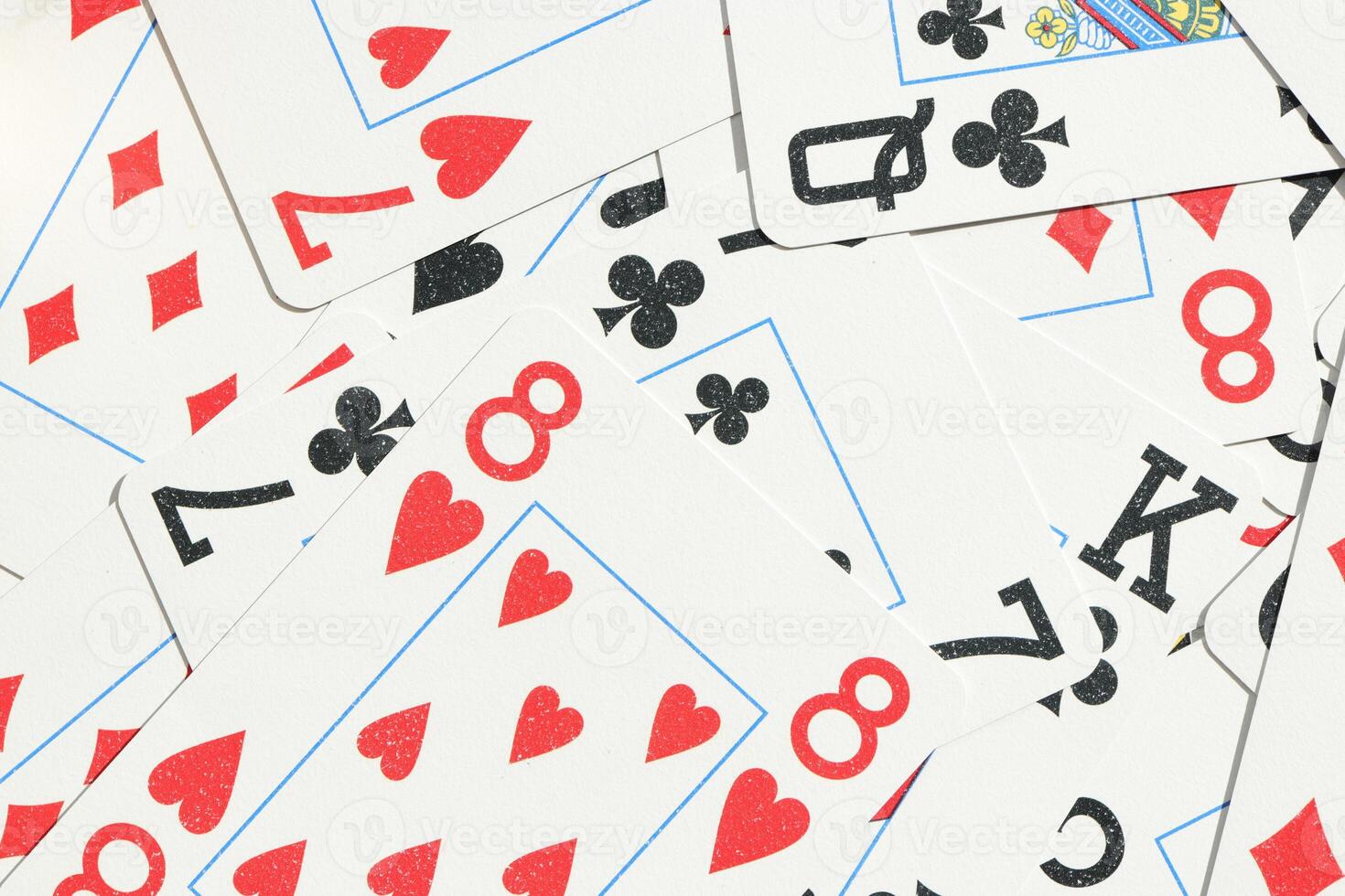 Mixed playing cards background. Assorted play cards backdrop. Many miscellaneous jumbled playing cards surface. photo