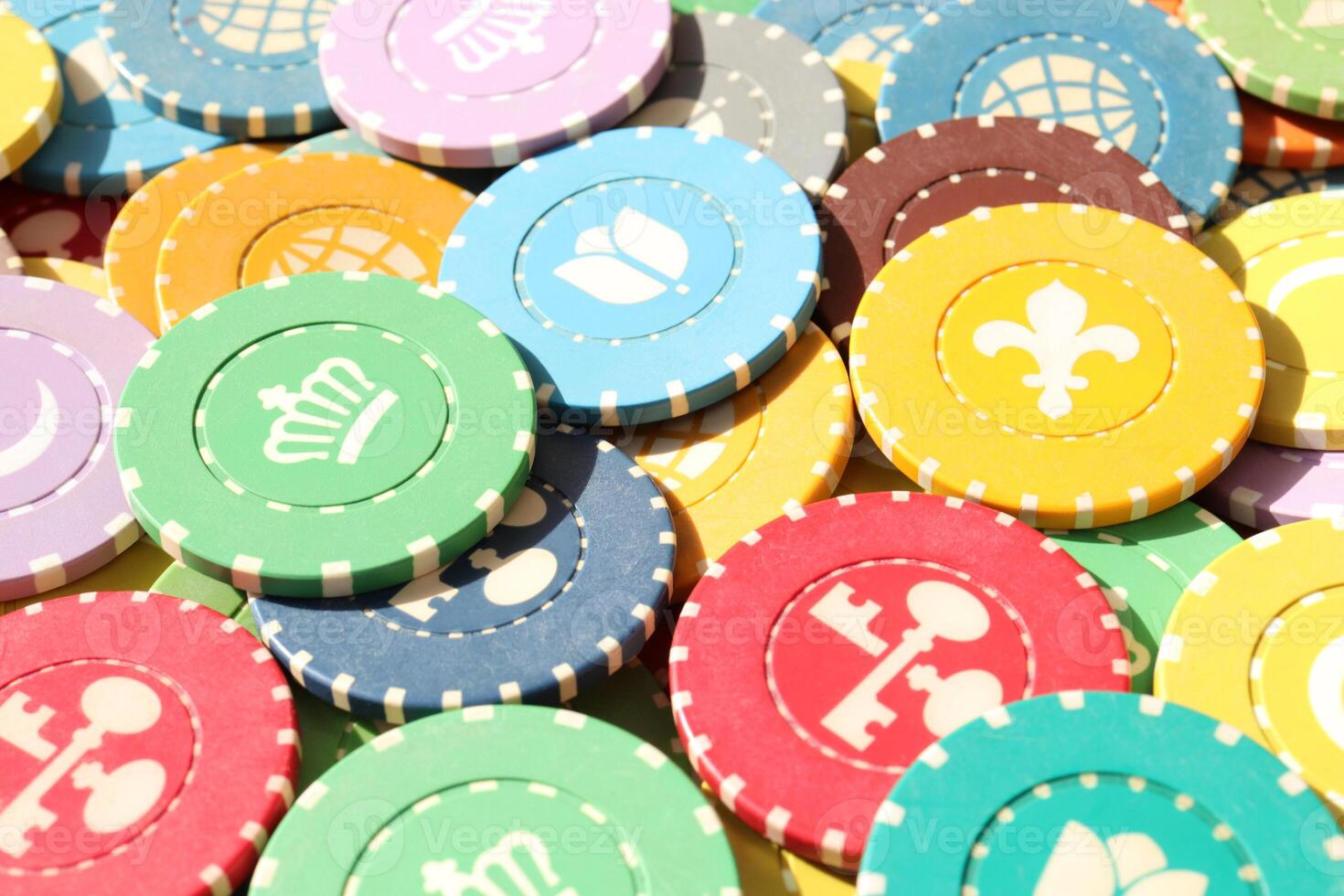Lot multicolor assorted gambling playing chips surface. Colorful casino chips background. Many colored chips backdrop. photo