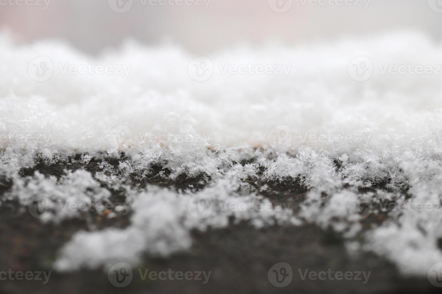 Snow lies on the old cement railing of the balcony photo