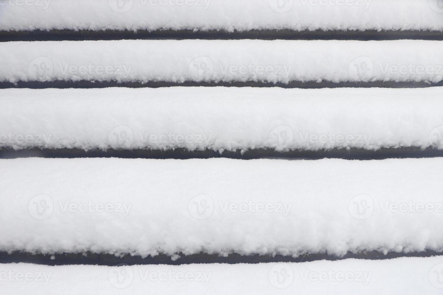 Pavilion under the flag round steps under a thick layer of snow. Landscape of winter park. photo