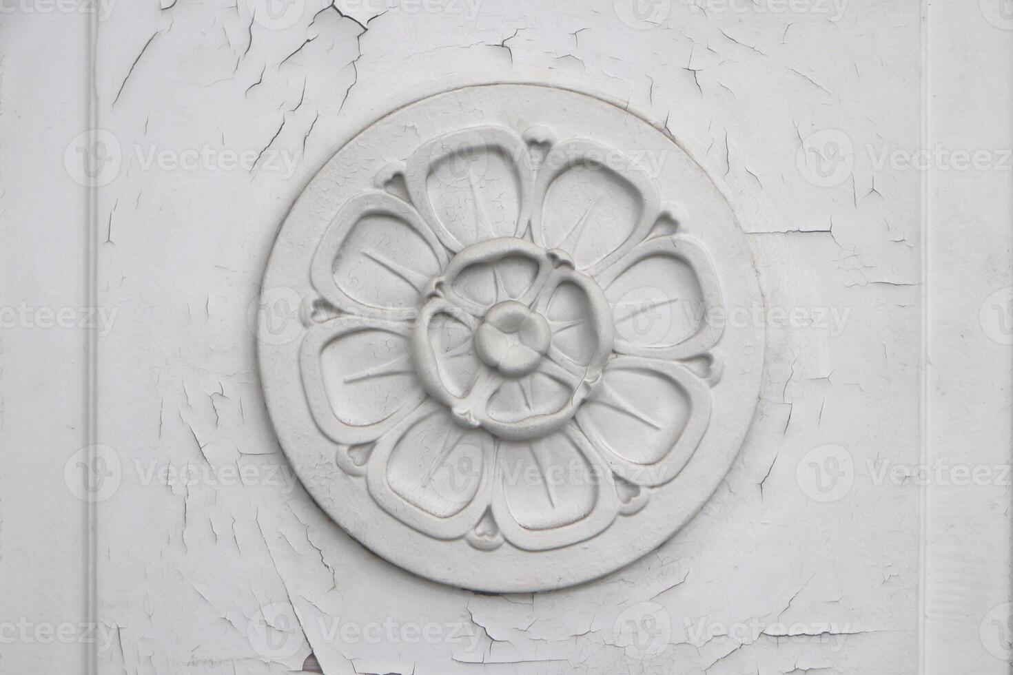 Flower stucco molding on the door. Vintage floral pattern. photo