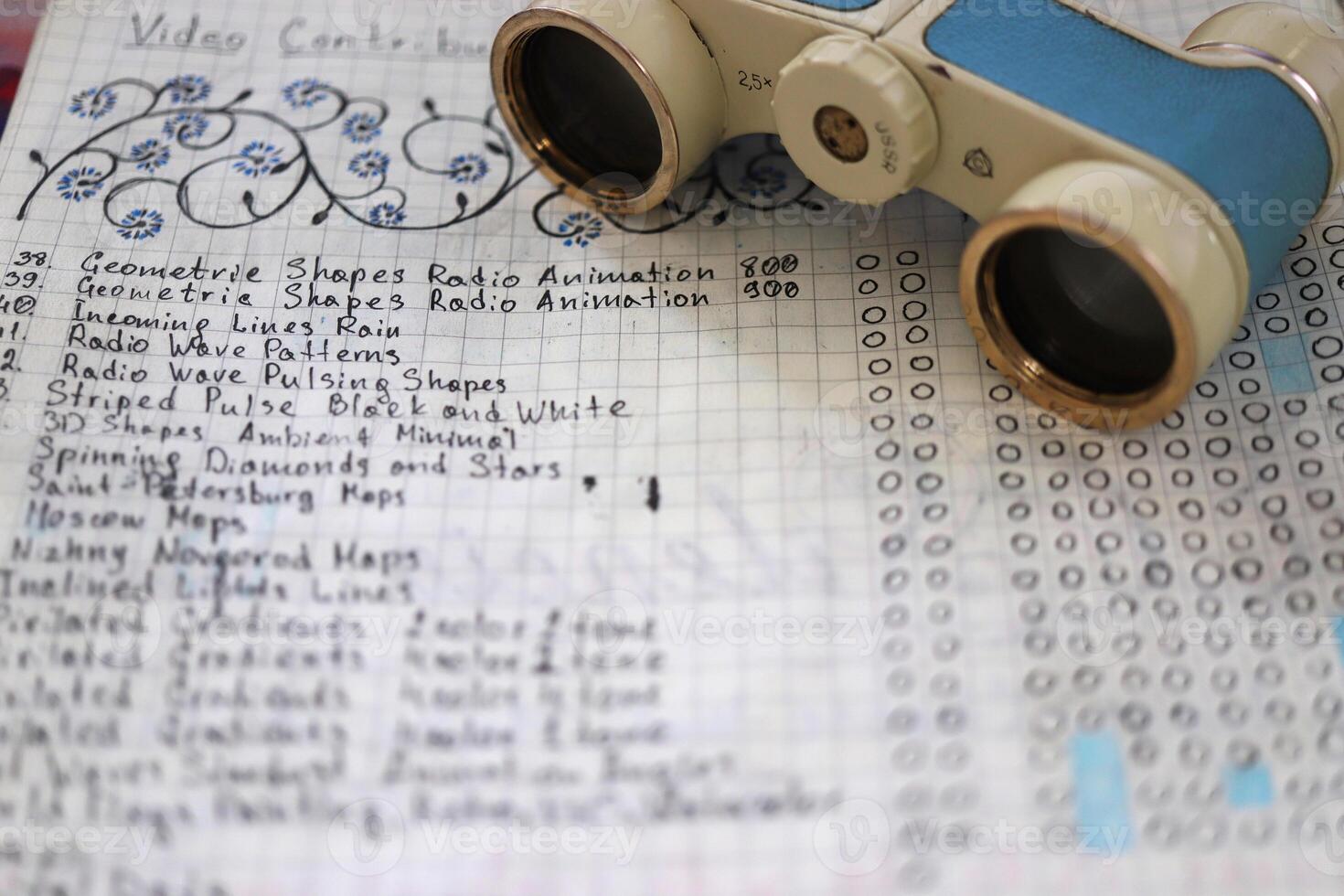 Sheet of notebook with to-do list and theater binoculars photo