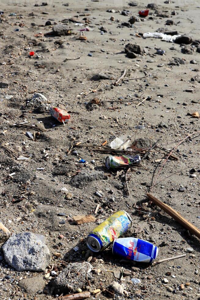 Lot of garbage on the sand. Dirty summer beach background. photo