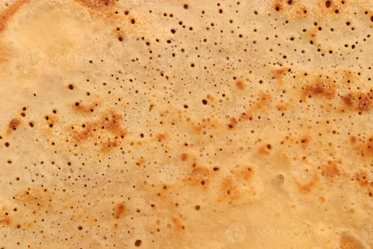 Light toasted traditional desert pancake pattern texture. Macro closeup. photo