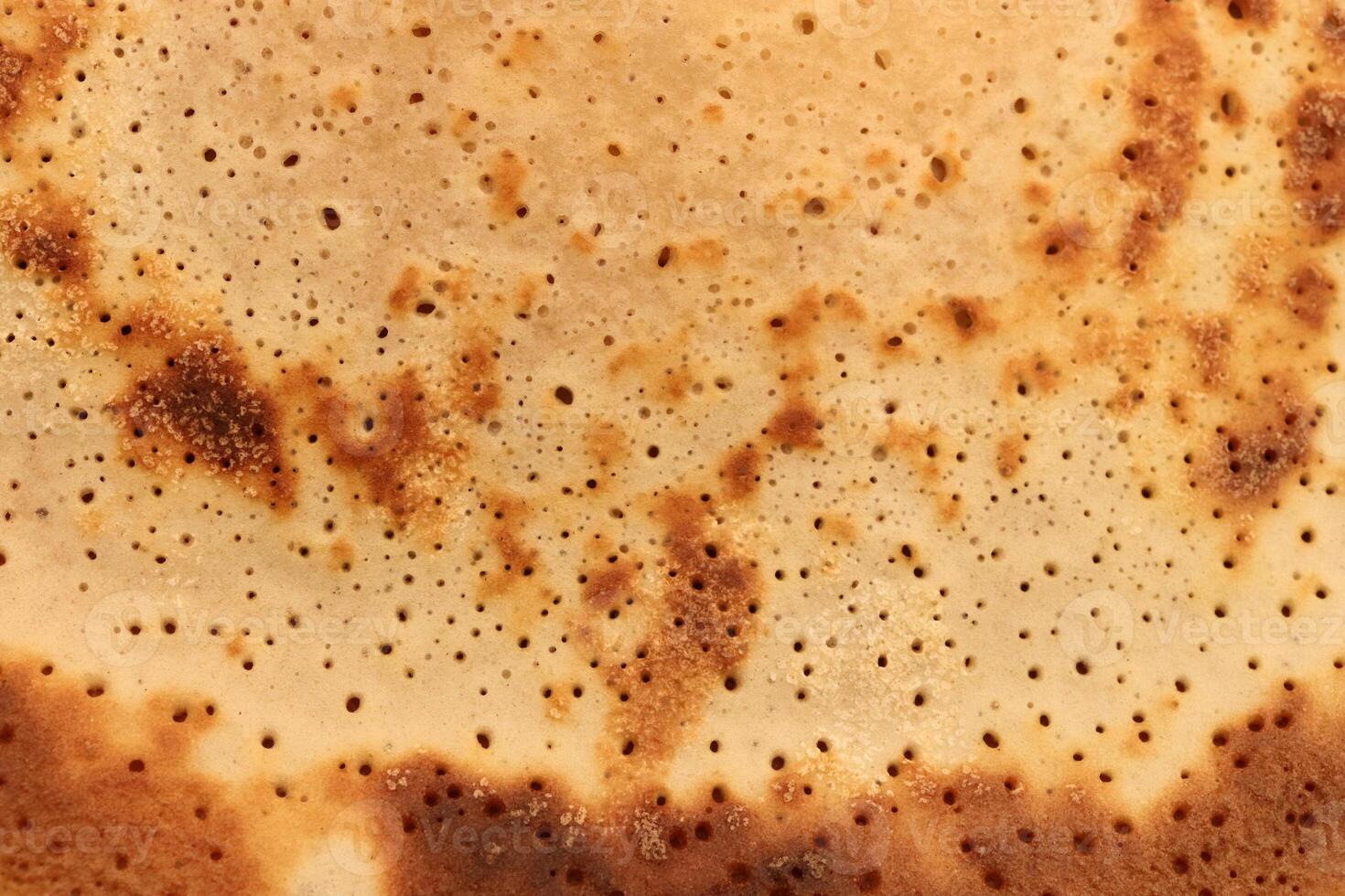 Toasted homemade pancake delicious backdrop texture. Macro closeup. photo