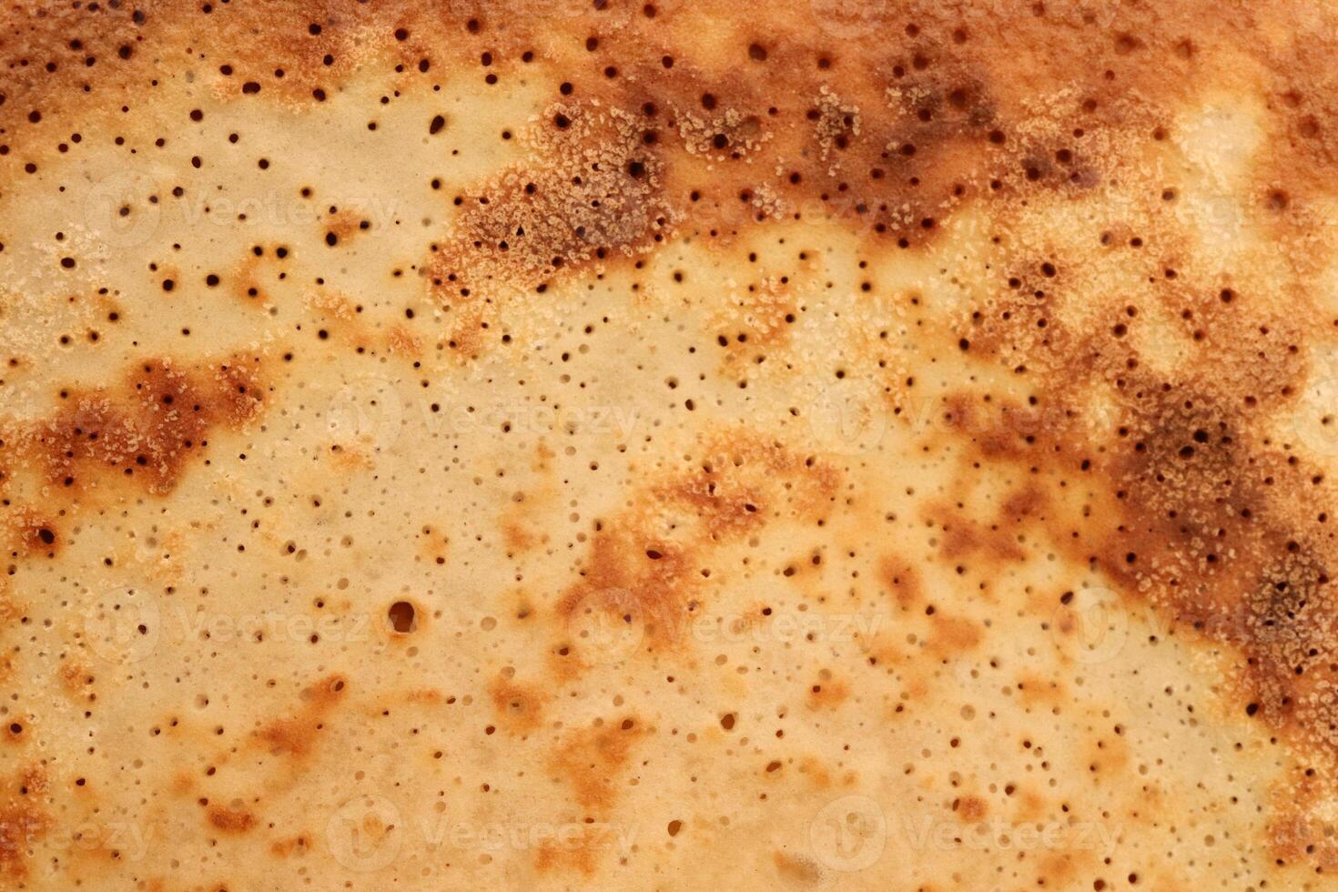 Toasted traditional desert pancake pattern texture. Macro closeup. photo